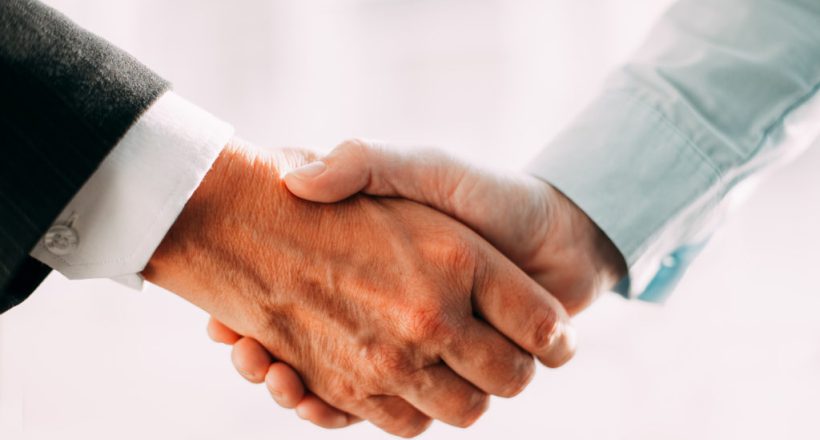 Close-up of business partners shaking hands