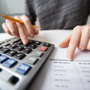 Closeup of Accountant Hands Counting on Calculator