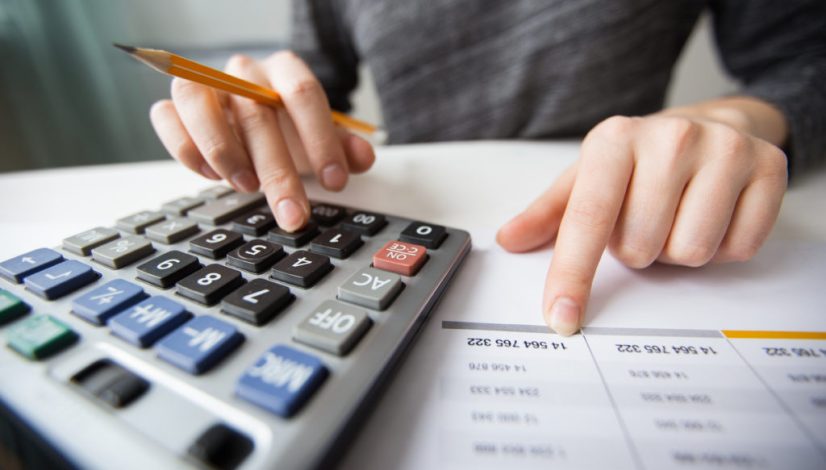 Closeup of Accountant Hands Counting on Calculator