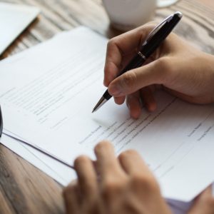 Businessman examining papers at table