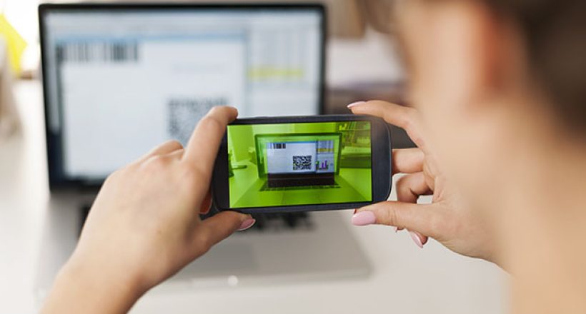 Woman scanning qr code to pay bills